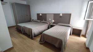 Ένα ή περισσότερα κρεβάτια σε δωμάτιο στο Hotel Peña Cruz