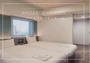 Postel nebo postele na pokoji v ubytování Henn na Hotel Tokyo Hamamatsucho