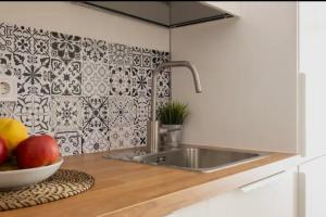 a kitchen with a sink and a bowl of fruit at Apartment close to the beach in Sant Adria de Besos +20 photos