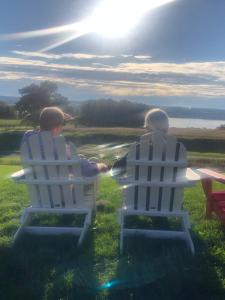 two people sitting in lawn chairs watching the sunset at The Fallen Tree Inn in Geneva