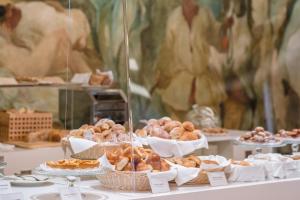 a display of pastries on a table in a bakery at Hotel Royal Continental in Naples