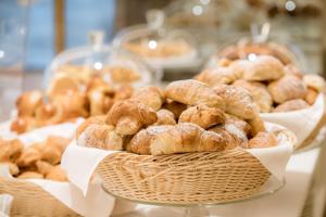 a bunch of donuts in baskets on a table at Hotel Royal Continental in Naples