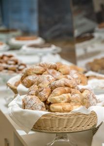 a basket of donuts sitting on a table at Hotel Royal Continental in Naples