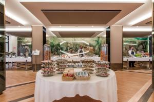 a table with cakes and baskets on it in a room at Hotel Royal Continental in Naples