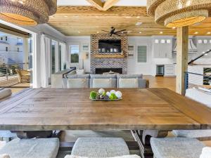 a dining room with a large wooden table and chairs at Summer Wind home in Seagrove Beach