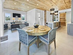a dining room and living room with a table and chairs at Summer Wind home in Seagrove Beach