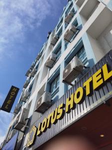 a hotel sign on the front of a building at Lotus Hotel Seremban Near Palm Mall & KPJ Seremban in Seremban