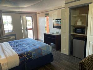 a bedroom with a bed and a desk and a television at KINGS INN- Medical Downtown Midtown Memphis in Memphis