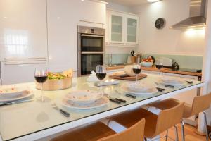 a kitchen with a table with glasses of wine at Vesta Cottage, Orford in Orford +10 photos