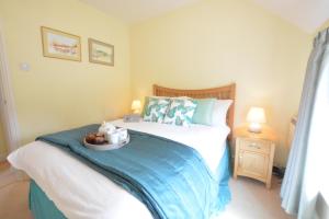 a bedroom with a bed with a bowl of fruit on it at Seafarers in Fressingfield