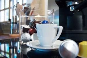 a white coffee cup sitting on a counter top at Chobbs Barn, Eye in Eye