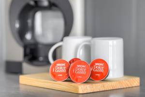 three red tags on a wooden cutting board with cups at MARGI Aicon VERY COZY OLD TOWN STUDIO in Szczecin +6 photos