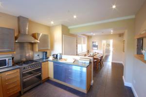 a kitchen with blue appliances and a dining room at Lavender House, Aldeburgh in Aldeburgh