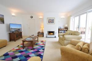 a living room with a couch and a table at Rippleway, Walberswick in Walberswick