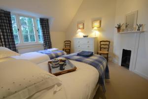 a bedroom with two beds with a tray on it at 2 The Bays, Thorpeness in Thorpeness