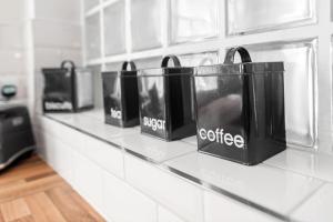 a counter with three black bags on a wall at Cool and Chic Duffield Road Apartments in Derby