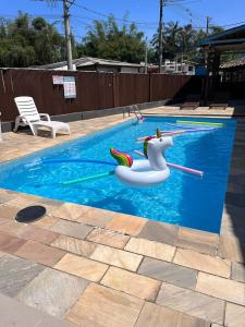 a pool with a unicorn float in a swimming pool at Chales da Lua Juquehy in Juquei