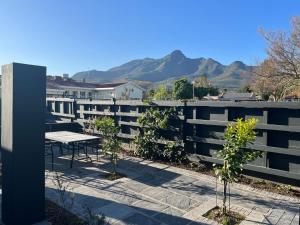 a balcony with a picnic table and mountains in the background at 28 on Symonds Luxstudio1 with solar backup in George