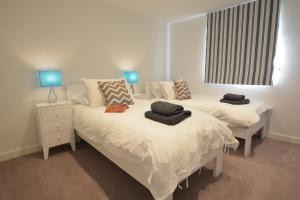 a bedroom with two beds with towels on them at Rush House, Eastbridge in Westleton