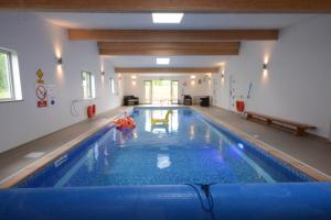 a person in an indoor swimming pool at Old Trout, Ubbeston in Laxfield