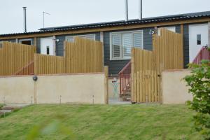 a fence in front of a house at Old Trout, Ubbeston in Laxfield