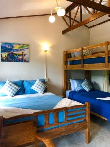 a bedroom with two bunk beds and a couch at Baan Chan Lay Koh Chang in Ko Chang