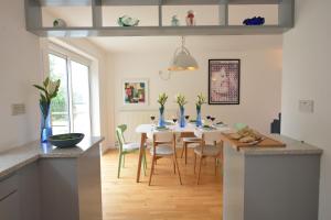 a kitchen and dining room with a table and chairs at Aldeburgh Lodge Gardens in Aldeburgh