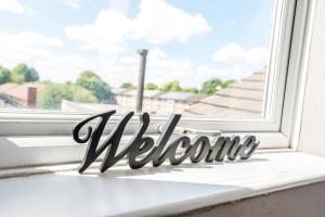 a welcome sign sitting on a window sill at Cool and Chic Duffield Road Apartments in Derby