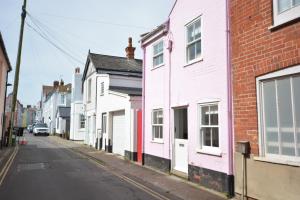 a row of white houses on a street at Alinka, Aldeburgh in Aldeburgh