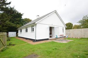 a small white house with a yard at Field Edge, Tunstall in Tunstall