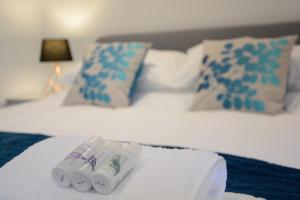 a bedroom with two beds with blue and white pillows at Skylight, Aldeburgh in Aldeburgh