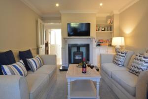 a living room with two couches and a fireplace at Neptune in Aldeburgh