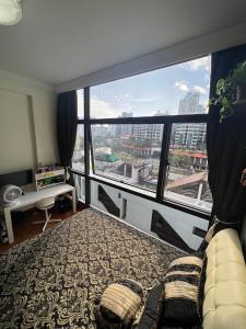 a bedroom with a bed and a large window at River Place in Singapore