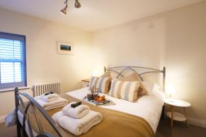 um quarto com uma cama com toalhas em Smugglers Rest, Aldeburgh em Aldeburgh