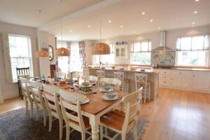 a kitchen and dining room with a wooden table and chairs at Cannons in Southwold