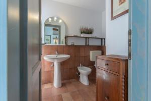 a bathroom with a sink and a toilet and a mirror at Francolino Duplex Charming La Farnia Villa in Francolino +24 photos