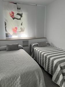a room with two beds and a painting on the wall at El Gallinero in Almoharín +67 photos