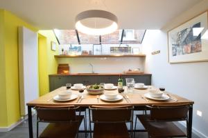 a kitchen with a wooden table with chairs around it at 37 Stradbroke Road, Southwold in Southwold +22 photos