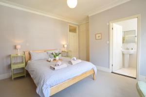 a bedroom with a bed with two towels on it at 14 Dunwich Road, Southwold in Southwold