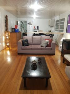 a living room with a couch and a coffee table at Casa Aurora in Cambara do Sul