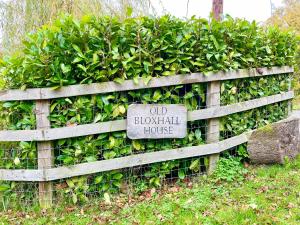 a wooden fence with a sign that reads old blossom house at Old Bloxhall House, Hitcham in Lavenham