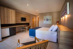 a hotel room with a bed and a desk at La Torre Resort All Inclusive in Porto Seguro