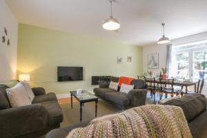 a living room with couches and a dining room at The Gallery, Blythburgh in Blythburgh