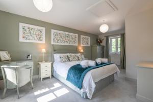 a bedroom with a bed with two stuffed animals on it at 1 Coconut Cottage, Long Melford in Long Melford