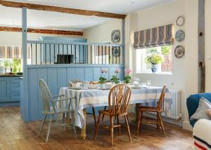 a dining room with a table and chairs at Stable Cottage at the Grove, Great Glemham in Framlingham