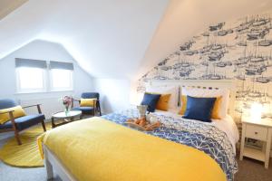 a bedroom with a large bed with a mural on the wall at Driftwood, Southwold in Southwold