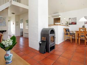 a fireplace in the middle of a living room at 4 person holiday home in Bl vand in Blåvand