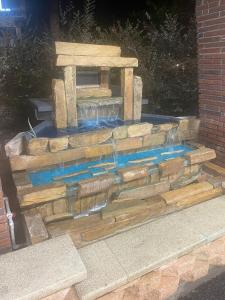 a stone fountain in the middle of a patio at BlueGem Motel in High Springs