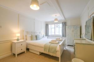 a bedroom with a white bed and a window at Beresford House in Woodbridge