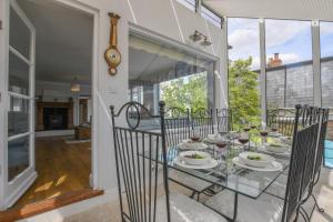 a dining room with a glass table and chairs at Beresford House in Woodbridge